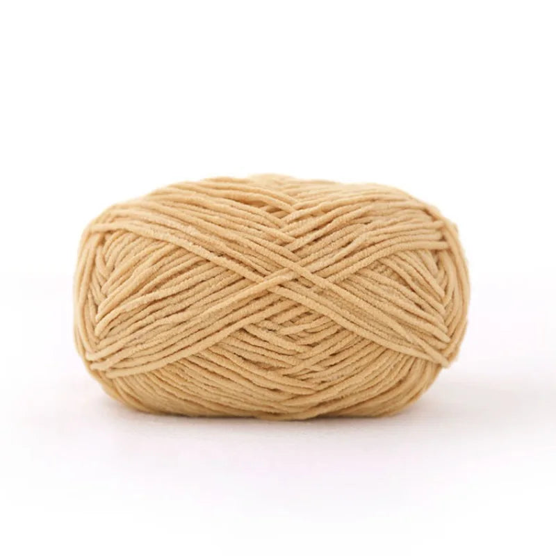 A ball of tan matte chenille yarn used for knitting and crochet
