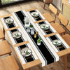 A set of minimalist black and white placemats and table flags laid out on a wooden table.
