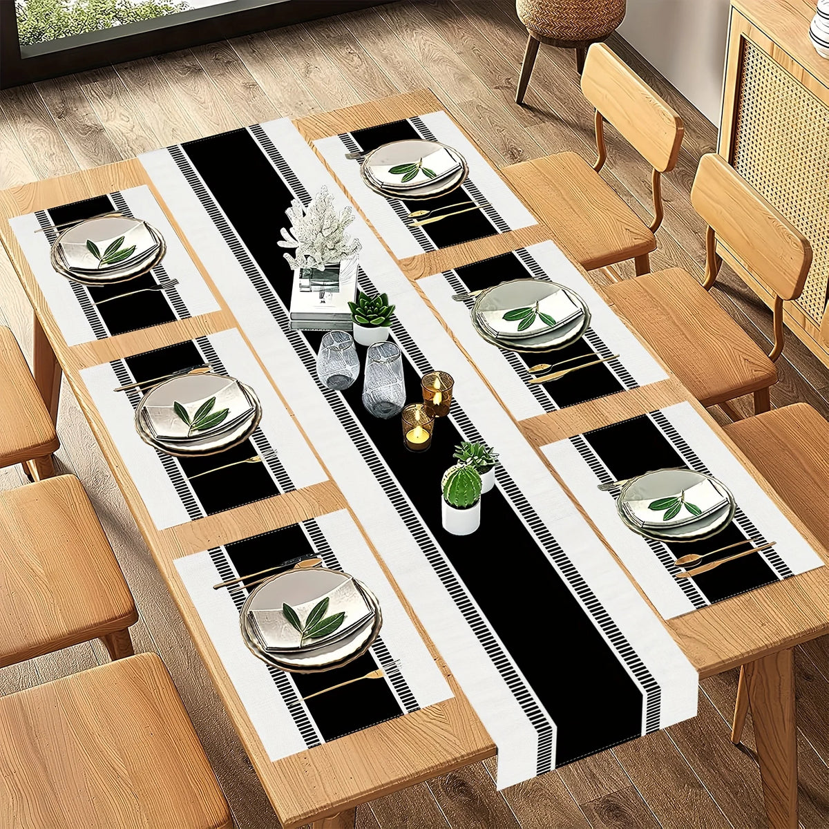 A set of minimalist black and white placemats and table flags laid out on a wooden table.