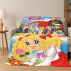 A colorful cartoon flannel blanket featuring a blonde girl character with pink hair and a red bow.
