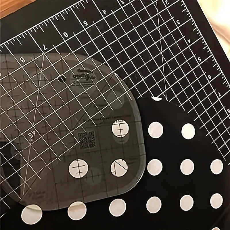 A clear acrylic quilting ruler with corner templates is shown on a black background with a grid and measurement markings.