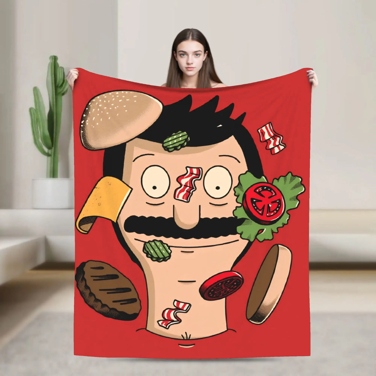 A red throw blanket featuring a cartoon illustration of a man with a mustache and a burger head.