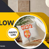 A white decorative pillow with an Aperol Spritz design is shown in a modern living room setting.