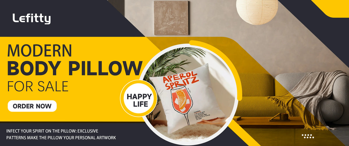 A white decorative pillow with an Aperol Spritz design is shown in a modern living room setting.