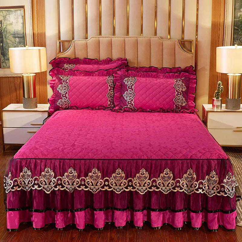 A vibrant pink quilted bed skirt set featuring a magenta comforter and matching pillows.