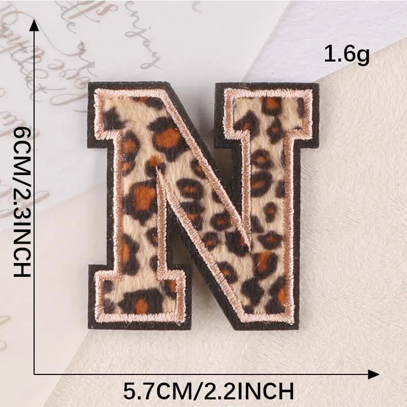 A leopard print alphabet letter N iron-on patch shown with size measurements.