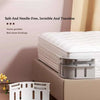 A set of white invisible bed sheet fasteners and bindings displayed on a wooden surface.