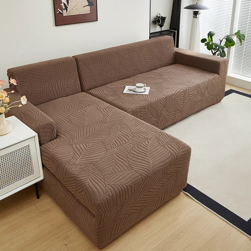 A brown sofa slipcover featuring a jacquard leaves pattern placed in a modern living room.