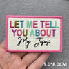 Pink embroidered patch with the text Let me tell you about My Jesus in multicolored thread