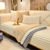A beige plush sofa seat cushion cover with vertical pleats and a gray accent cushion on a light-colored sofa.