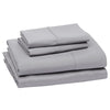 A stack of four gray microfiber flat fitted sheets folded neatly.