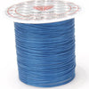 A spool of blue crystal string with a decorative label featuring a star pattern.