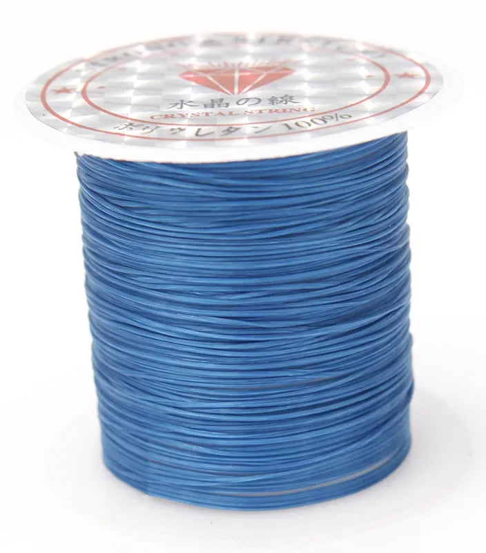 A spool of blue crystal string with a decorative label featuring a star pattern.