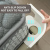 A hand is holding a white bed corner sheet gripper designed to prevent slipping.