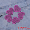 Five glitter iron-on embroidered love heart star patches on a denim fabric.