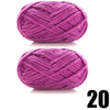 A ball of thick purple velvet yarn used for knitting and crochet projects.