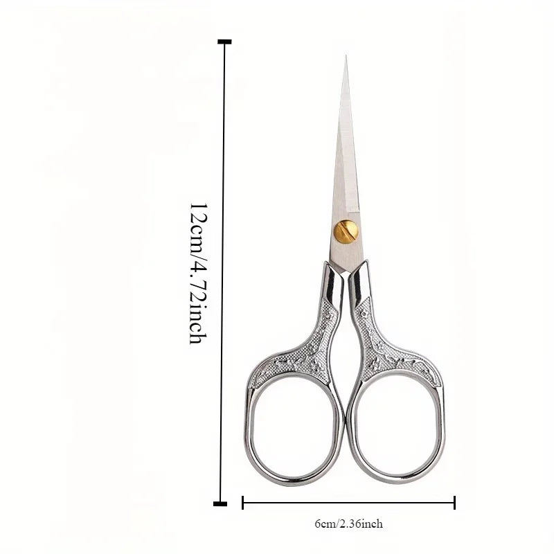 Stainless steel vintage sewing scissors with a pointed blade and silver handles