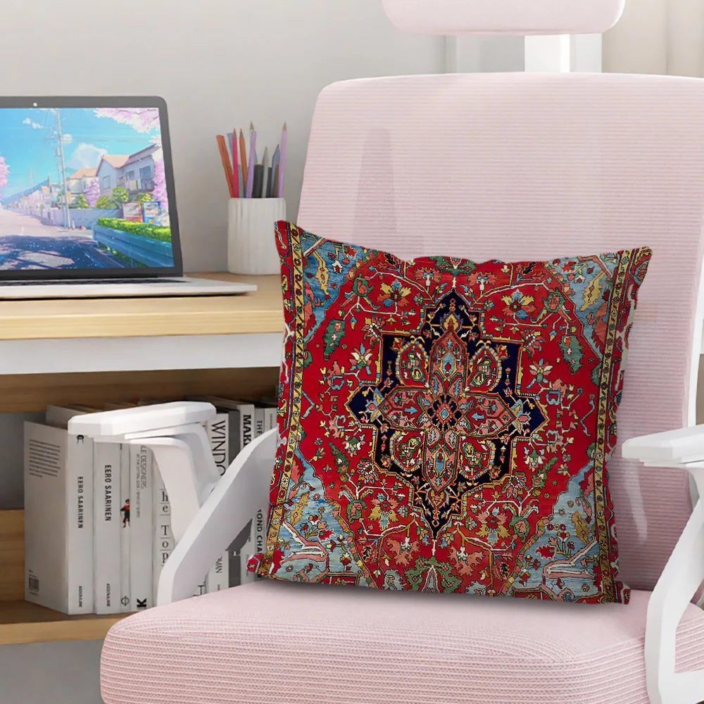 A red and blue Persian pattern decorative cushion cover resting on a pink chair.