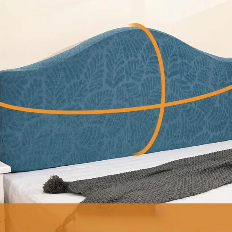 A teal headboard cover featuring an orange diagonal stripe design on a bed.