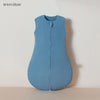 A light blue muslin cotton baby sleeping bag lying flat on a surface.