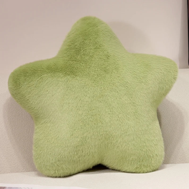 A soft, light green star-shaped decorative throw pillow.