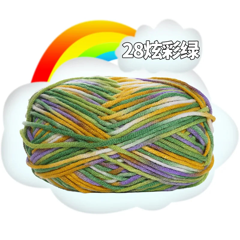 A ball of multi-colored yarn with various shades of green, yellow, and purple is shown against a white cloud background.