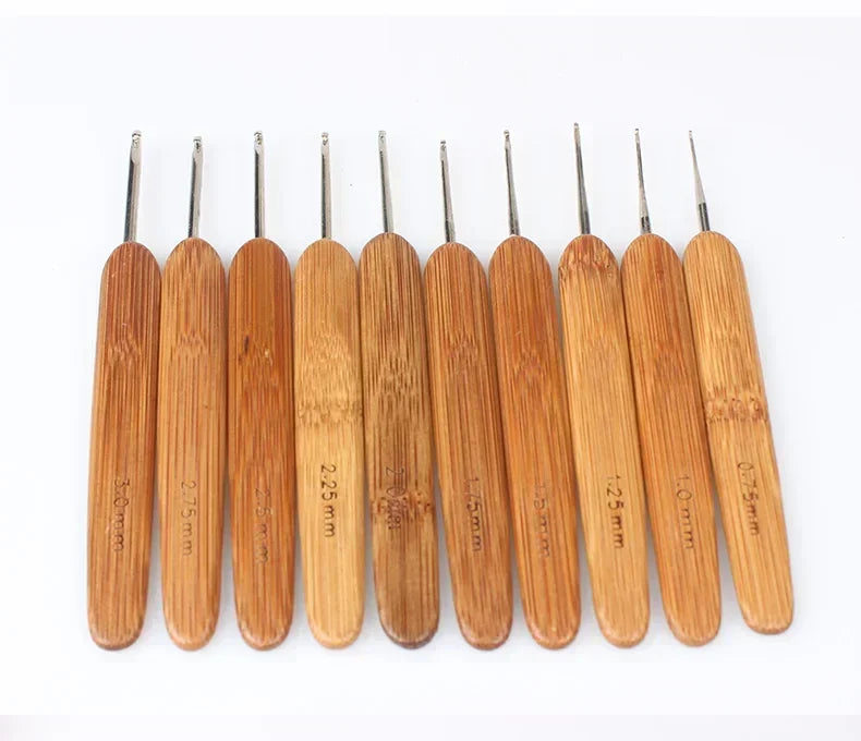 A set of ten bamboo crochet knitting needles with varying sizes displayed horizontally.