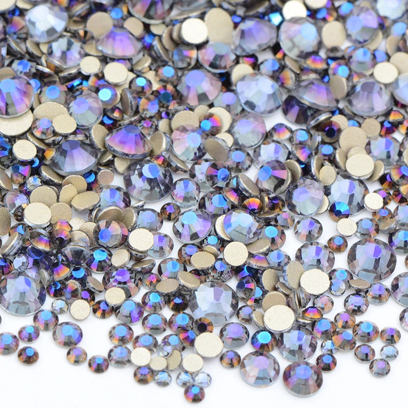 A close-up view of a mix of clear and iridescent glass rhinestones for DIY crafts.