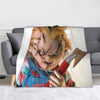 A throw blanket featuring a graphic of Chucky with facial injuries and a knife.