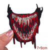 Black embroidery patch featuring a stylized rose skull design with red and cream accents