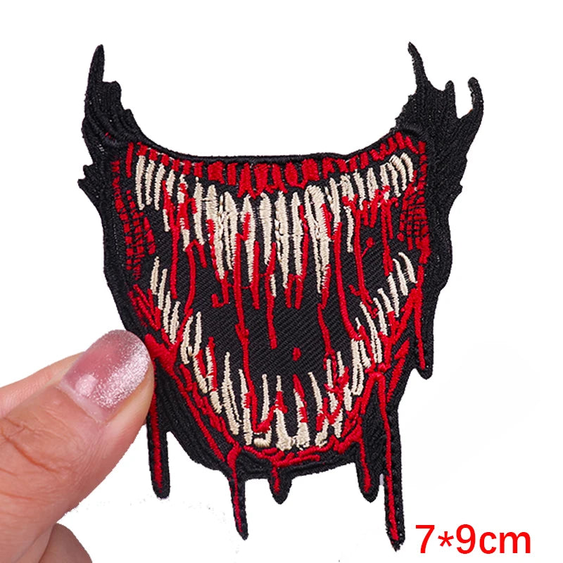 Black embroidery patch featuring a stylized rose skull design with red and cream accents