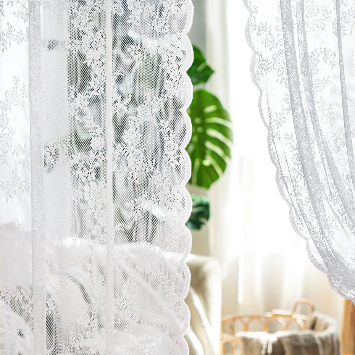 White floral lace sheer curtain hanging in a bright room
