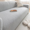 A light gray Jacquard velvet sofa cover with a decorative cushion and snacks on the seat.
