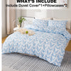A light blue heart print duvet cover set displayed on a bed with white pillows and a gray rug.