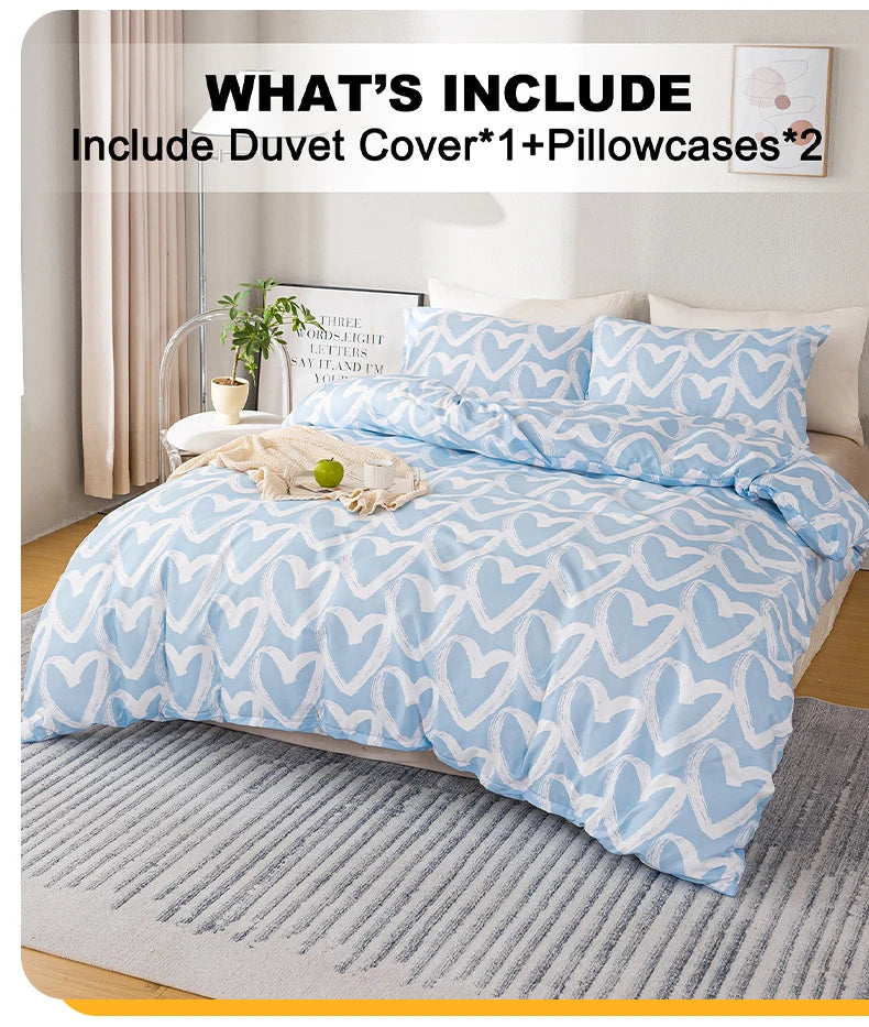 A light blue heart print duvet cover set displayed on a bed with white pillows and a gray rug.