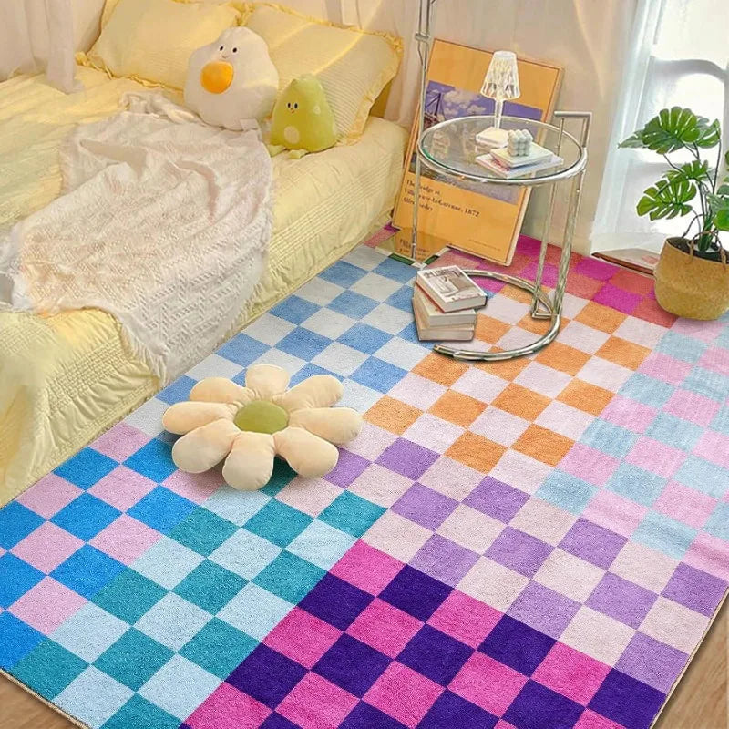 A colorful retro checkerboard geometric rug featuring pink, purple, blue, and green squares.
