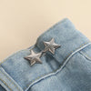 Silver star-shaped button clips attached to a blue denim fabric