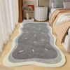 A gray and beige seasonal decor rug with light lines placed on a light wood floor.