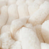 A close-up view of two white plush fabric items, likely pillowcases, with a soft, fluffy texture.