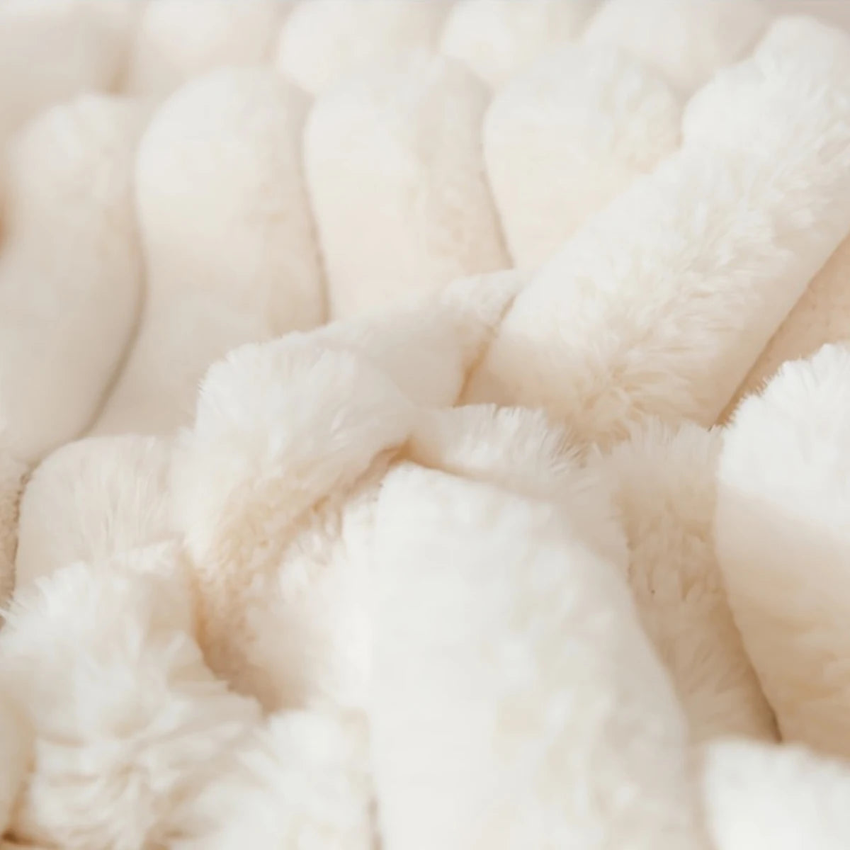 A close-up view of two white plush fabric items, likely pillowcases, with a soft, fluffy texture.