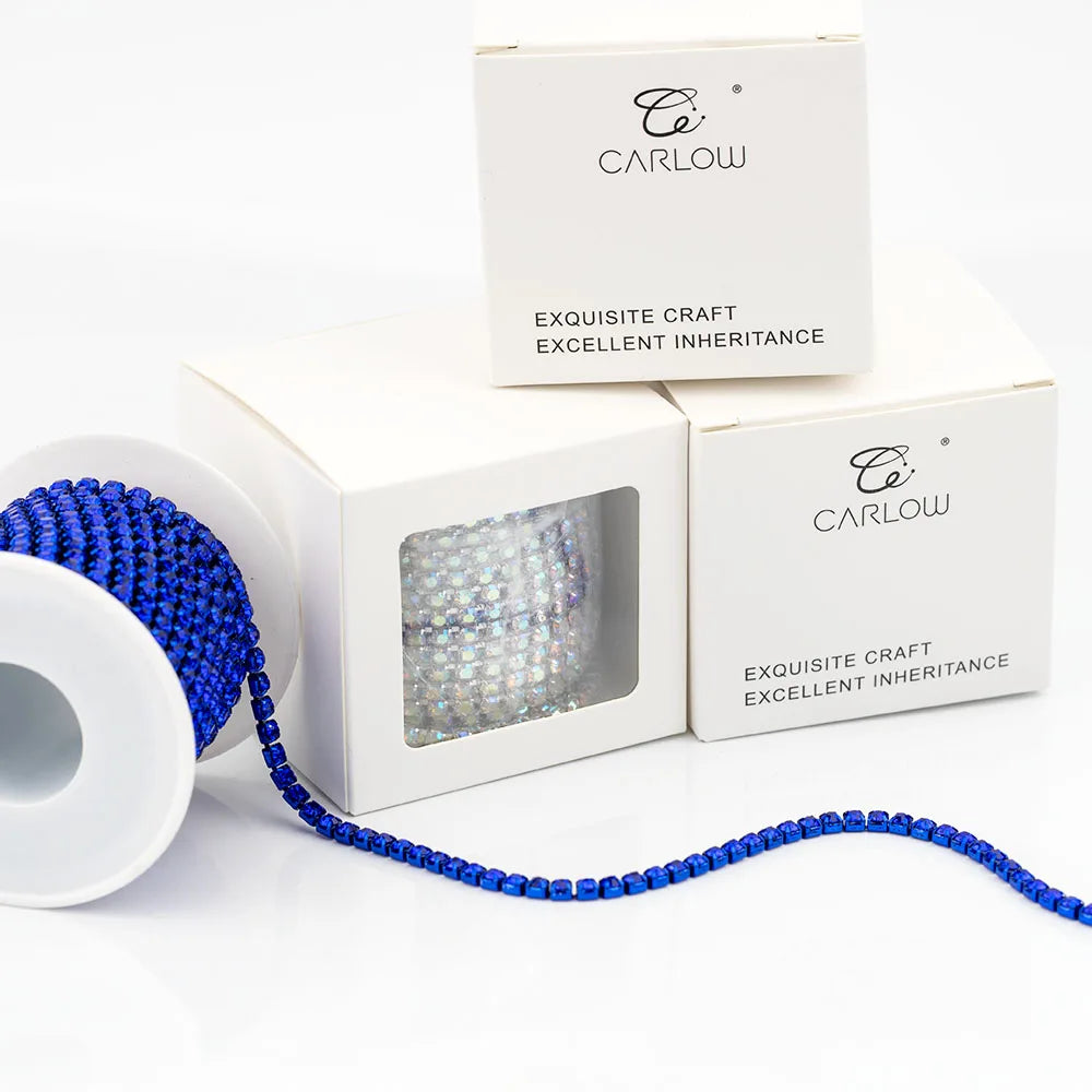 A box of Carlow exquisite craft glass rhinestone chains for DIY decoration with a blue chain displayed outside the box.