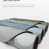 Rolls of multi-use non-slip floor mats in various shades of gray and green displayed on a white surface.