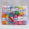 A collection of 12 colors of milk cotton yarn spools packaged for a crochet kit.