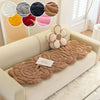 A beige sofa features a brown textured mat with a floral embellishment and color swatches.