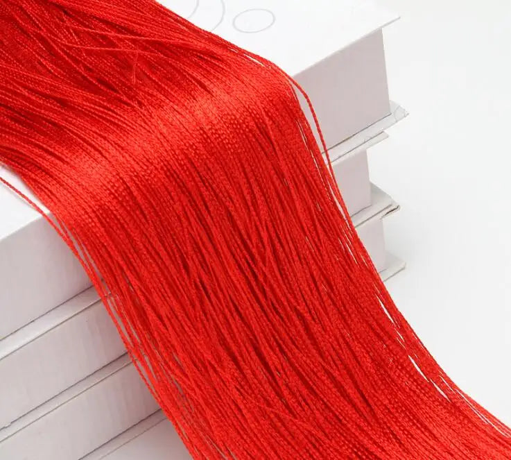 A long, bright red thread curtain tie-back is displayed next to a white box.