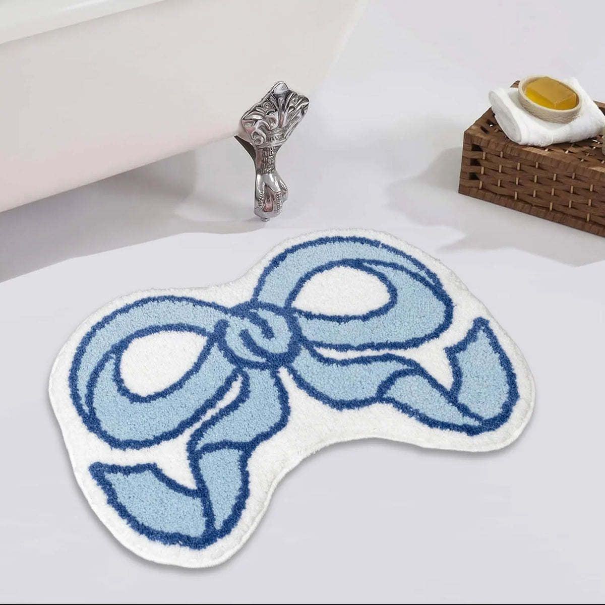 A light blue and white fluffy decor rug shaped like a bow is displayed next to a silver figurine.