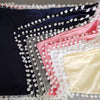 Elegant elastic bed skirt in various colors including navy blue, gray, pink, and cream with white fringe.