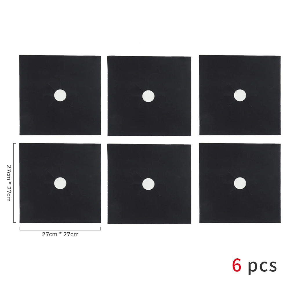 A set of six black square protectors with white circular inserts for a gas stove.