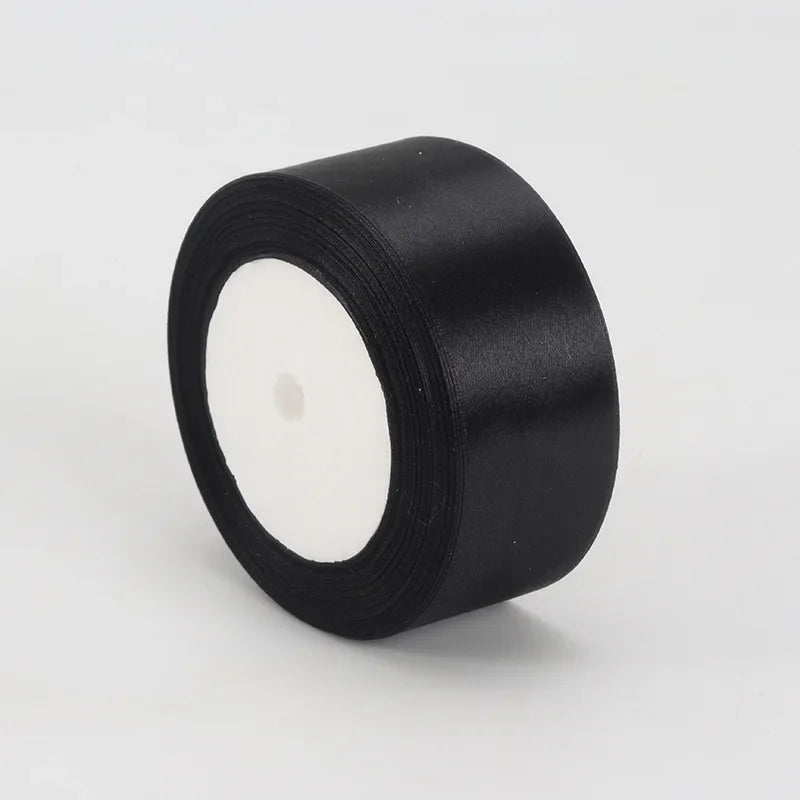 A roll of black satin ribbon measuring 4cm for crafts and gift wrapping.