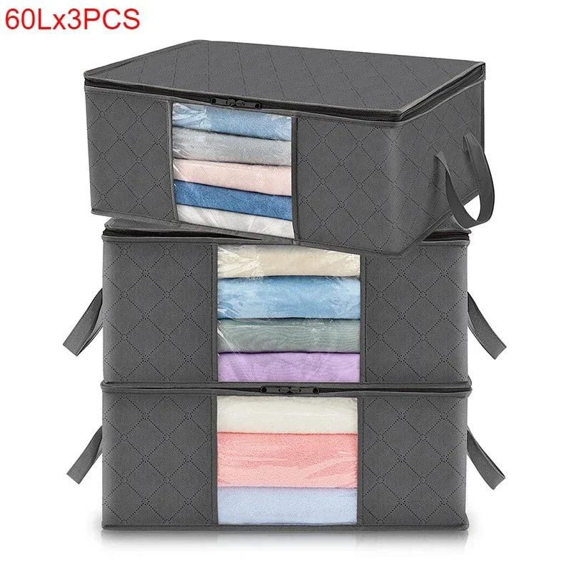 Three stacked gray storage bags with visible layers of light blue, pink, and purple fabric inside